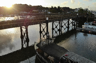 Aerial view of Lymington harbor and a bridge with tracks, taken in the early morning.