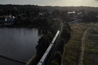 Aerial drone footage of a South Western Railway train traveling through Poole Park, Dorset.