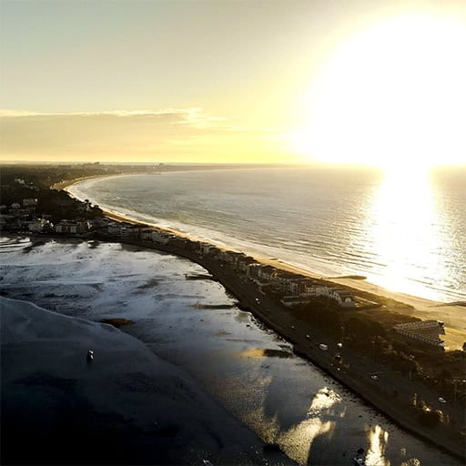Aerial drone photo of Sandbanks, Dorset, at dawn, showing the coastline and beach